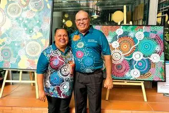 Kylie Hill with her husband David and some examples of her artwork.