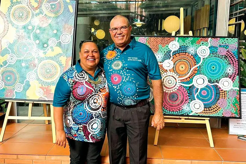 Kylie Hill with her husband David and some examples of her artwork.