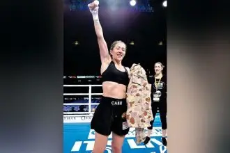 Jessica Cashman celebrates a win in the ring.