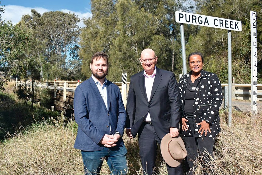 Federal Member for Blair Shayne Neumann, centre, with Ipswich City Council Division 1 councillors Jacob Madsen and Pye Augustine in front of the Purga bridge which will undergo a major upgrade.