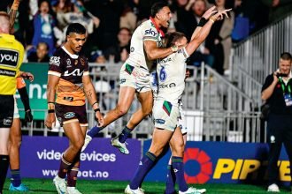 Warriors Freddy Lussick and Marcelo Montoya celebrate a try against the Broncos. PHOTO: AAP