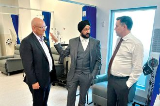 Shayne Neumann and Minister for Health and Aged Care Mark Butler speak with the Ipswich Urgent Care Clinic’s Dr Ajit Bhalla.
