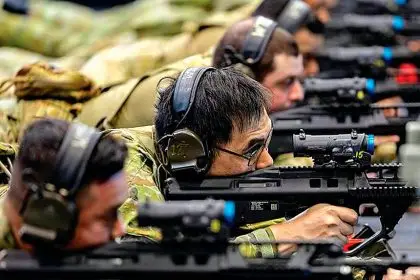 Leading Aircraftman Henry Lam (centre) from No 23 Squadron at the Weapons Training Simulation System at the RAAF Base at Amberley.