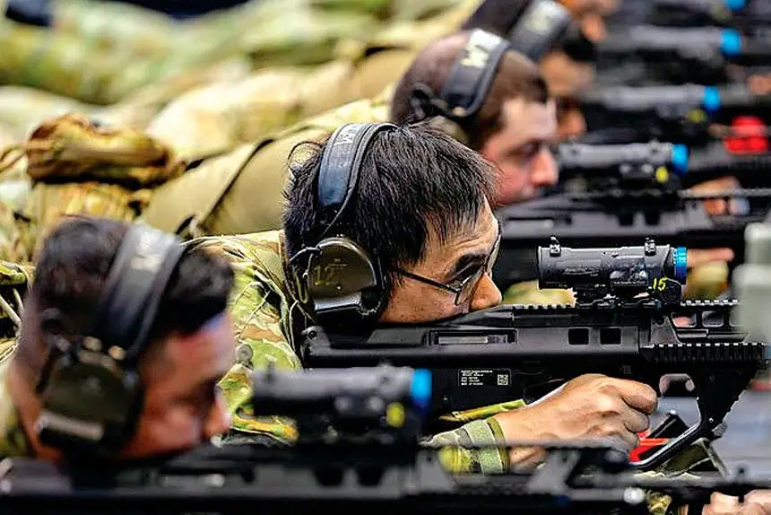 Leading Aircraftman Henry Lam (centre) from No 23 Squadron at the Weapons Training Simulation System at the RAAF Base at Amberley.