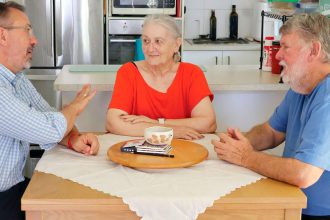 Carl Mutzelburg with pensioners Janice and John James.
