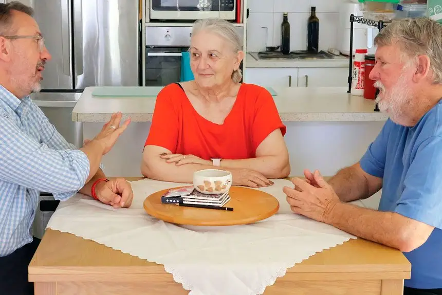 Carl Mutzelburg with pensioners Janice and John James.