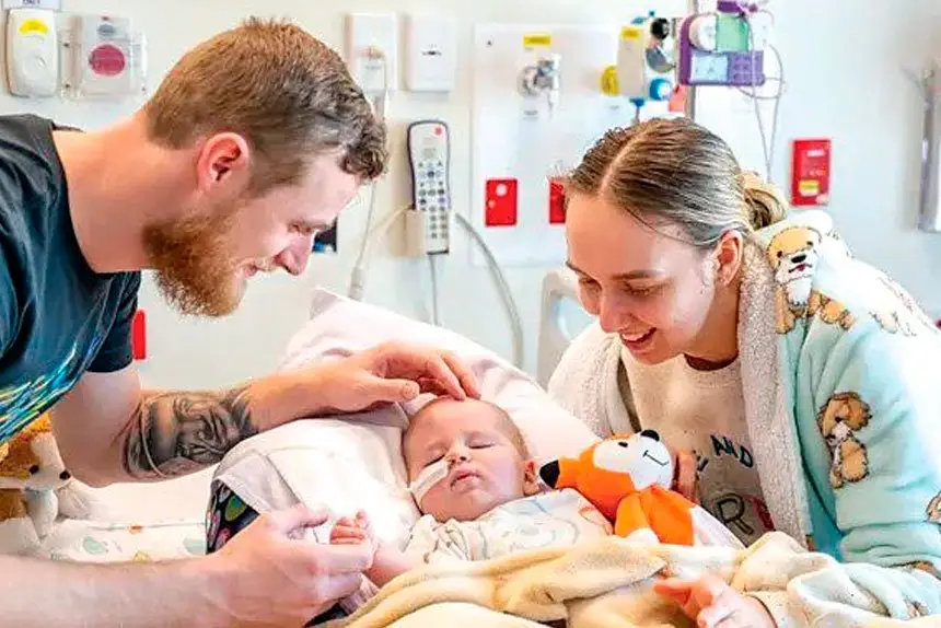 LITTLE BATTLER: Jenson with his parents Brianna Dalton and Jesse Carlile.