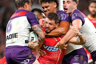 Dolphins forward Ray Stone is well held by the Storm defence. PHOTO: AAP Image/Dave Hunt