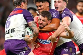 Dolphins forward Ray Stone is well held by the Storm defence. PHOTO: AAP Image/Dave Hunt