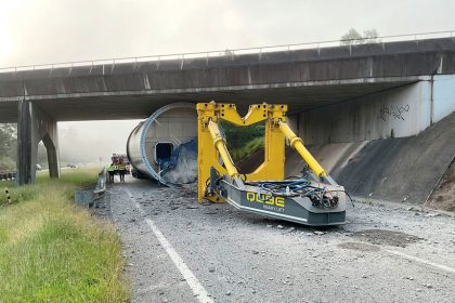 STUCK TIGHT: The turbine tower lies under the overpass.