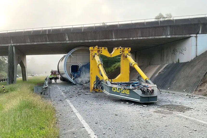STUCK TIGHT: The turbine tower lies under the overpass.