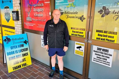 The locked door policy is highlighted on a sign outside of the shop.