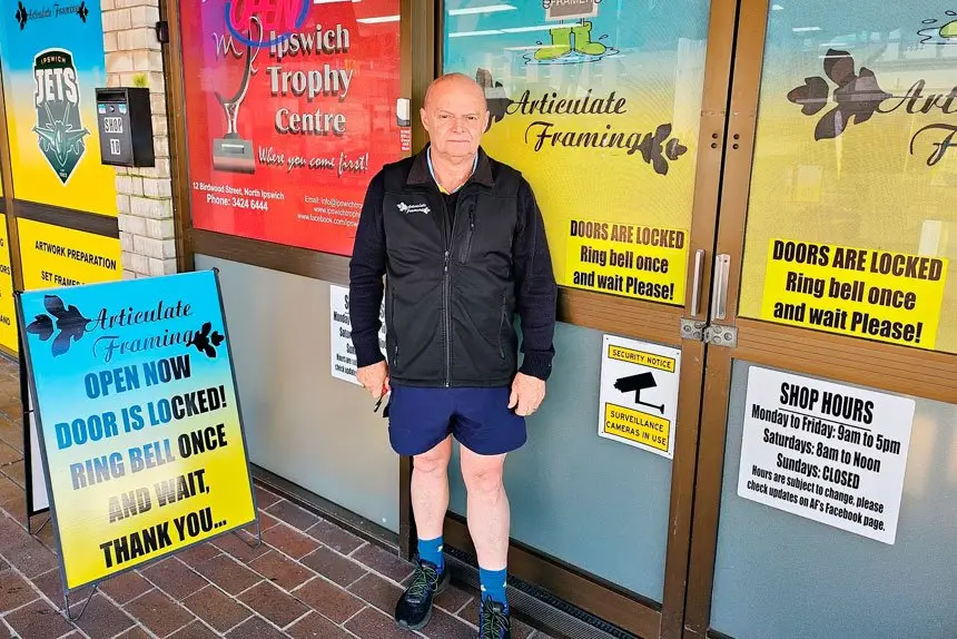 The locked door policy is highlighted on a sign outside of the shop.