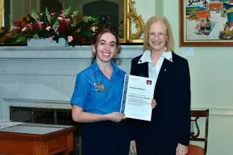 AWARD HONOUR: Rebecca McMahon receives her award from the Governor of Queensland Jeanette Young.