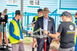 WHEELS OF CHANGE: Federal Member for Blair Shayne Neumann met with Bremer State High School students participating in a workshop run by the charity TRACTION For Young People in which participants get to build their own bike.
