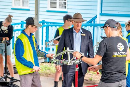 WHEELS OF CHANGE: Federal Member for Blair Shayne Neumann met with Bremer State High School students participating in a workshop run by the charity TRACTION For Young People in which participants get to build their own bike.