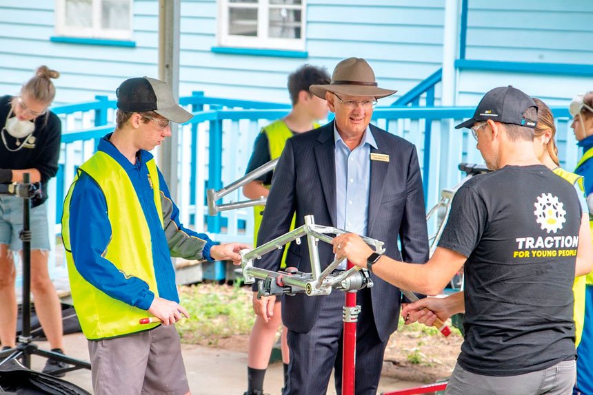 WHEELS OF CHANGE: Federal Member for Blair Shayne Neumann met with Bremer State High School students participating in a workshop run by the charity TRACTION For Young People in which participants get to build their own bike.