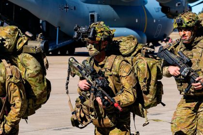 Australian Army soldiers from 7th Brigade walk past a German Air Force (Luftwaffe) A400M Atlas at RAAF Base Amberley.