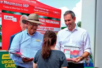 Federal Member for Blair Shayne Neumann and Treasurer Jim Chalmers speak with voters at a polling booth in Blair during the May election.