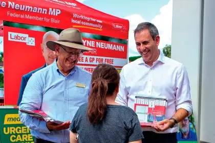 Federal Member for Blair Shayne Neumann and Treasurer Jim Chalmers speak with voters at a polling booth in Blair during the May election.