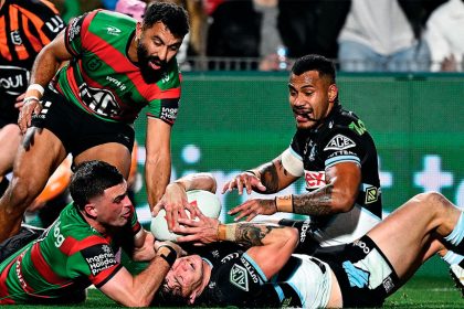 Nicho Hynes of the Sharks is held up by Lewis Dodd and denied a try against the Rabittohs. PHOTO AAP