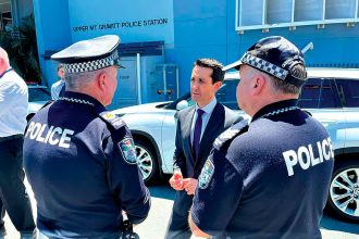 HELPING HAND: Premier David Crisafulli chats with police.