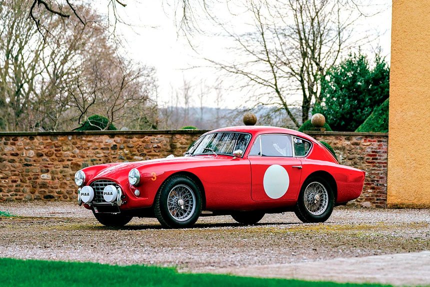 This meticulously restored 1957 AC Aceca-Bristo, finished in vivid red with white racing roundels, is being auctioned through RM Sotheby’s.