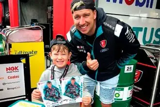 DREAM DAY: Young motorsport fan Ezra Woodforth with his Supercars hero Chaz Mostert.