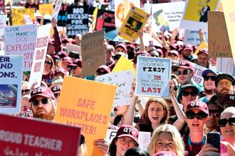 Striking teachers are seen protesting during a Queensland teachers strike in Brisbane earlier this month. PHOTO: AAP Image/Darren England
