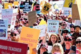 Striking teachers are seen protesting during a Queensland teachers strike in Brisbane earlier this month. PHOTO: AAP Image/Darren England