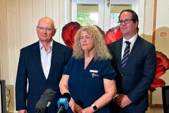 UNITED SUPPORT: Ipswich Legacy President Donna Reggett with Shayne Neumann and Matt Keogh.