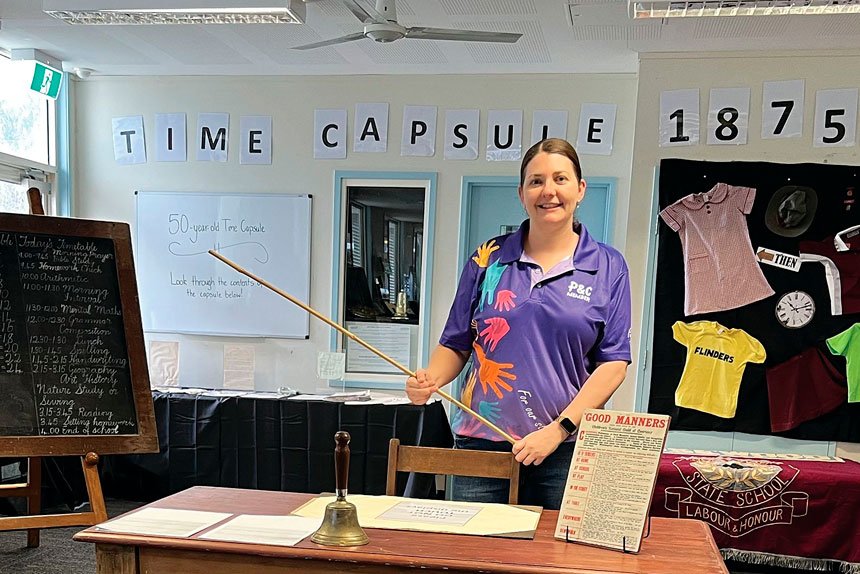 Rosewood State School Parents and Citizen Association President Jenna Culley at the school’s colonial school house and modern classroom display.