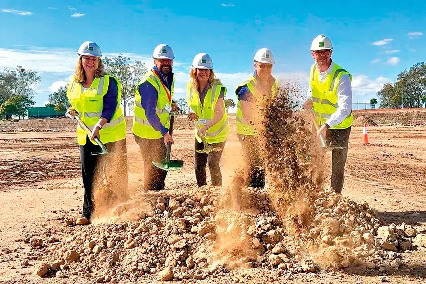 Mayor Teresa Harding, left, turns the sod on the Officeworks site at Redbank Motorway Estate with representatives from Officeworks and Goodman Group.