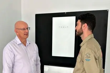 BRIGHT SUCCESS: Federal Member for Blair Shayne Neumann chats with Fallon Solutions technician Jade as he installs a solar battery.