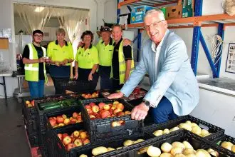 FEEDING THE NEEDY: Fred Muys and workers at the food co-op at the Tivoli Drive In site. The reclaimed food operation will remain open five days a week.