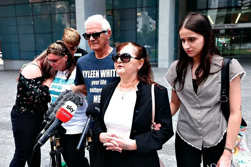ONGOING GRIEF: Vyleen White’s family, including daughter Cindy Micallef (centre), husband Victor White and grand daughter Caitlin Micallef, talk to the media outside the Brisbane Supreme Court. Photo: AAP Image/Jason O’Brien