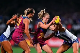 POWER PLAY: Brisbane Lions player Isabel Dawes fights for possession during the AFLW Grand Final against the North Melbourne Kangaroos at Ikon Park in Melbourne on Saturday. PHOTO: AAP Image/James Ross