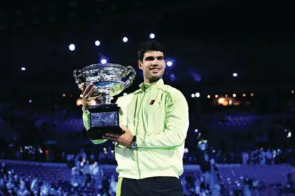 Carlos Alcaraz holds the trophy after winning the men’s singles final against Novak Djokovic at the 2026 Australian Open in Melbourne. PHOTO: AAP Image/Joel Carrett