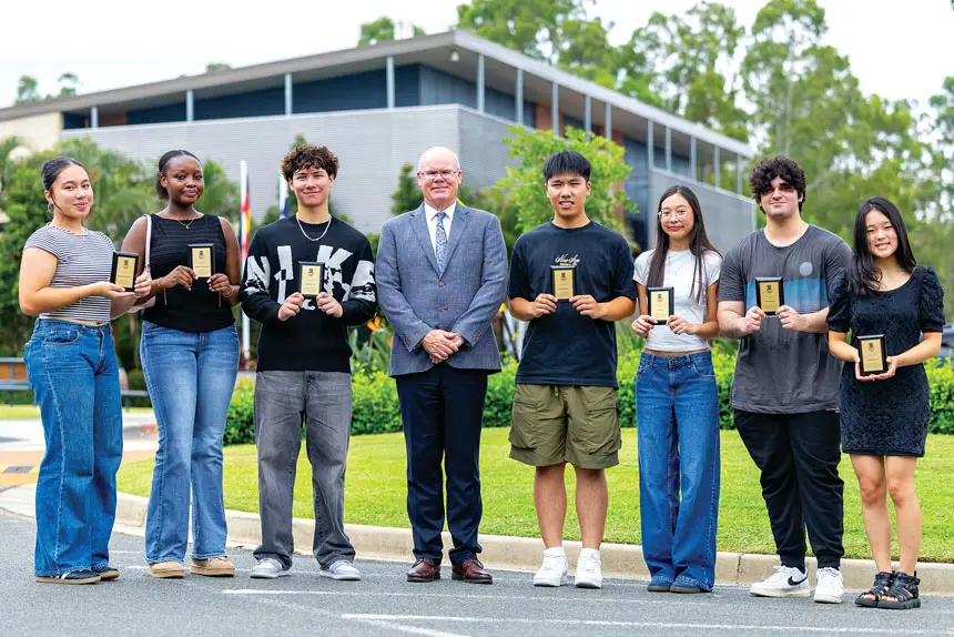 BRIGHT FUTURE: Principal Steven Morris and the successful students celebrate at the Scholars Assembly.