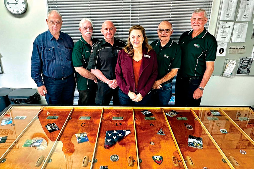 HISTORIC TABLE: Mayor Teresa Harding with Ipswich Men’s Shed members and local firefighters from Bundamba Fire and Rescue.