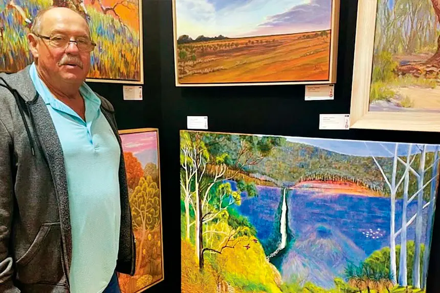 Denis Harold with his artwork The Outback Calls.
